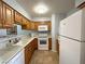 Kitchen featuring wood cabinets and white appliances and countertops at 2072 Mesquite Ln # 102, Laughlin, NV 89029