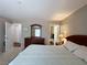 Spacious main bedroom with a king bed features neutral walls, dresser and full-length mirror at 2072 Mesquite Ln # 102, Laughlin, NV 89029