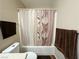Close-up shot of shower with flower-themed shower curtain and matching towels at 2072 Mesquite Ln # 102, Laughlin, NV 89029