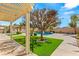 Lush backyard with manicured lawn, pool, and pergola providing shaded outdoor living at 215 Great Gable Dr, Las Vegas, NV 89183