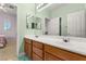 The bathroom features a double vanity, a framed mirror, and tiled flooring at 215 Great Gable Dr, Las Vegas, NV 89183
