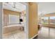 Bright bathroom with a large soaking tub, tiled walls, and dual ceiling fans at 215 Great Gable Dr, Las Vegas, NV 89183