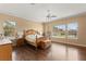 Sunlit bedroom with hardwood floors, ceiling fan, and large windows offering a bright, airy feel at 215 Great Gable Dr, Las Vegas, NV 89183