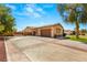 Large driveway with a three-car garage, providing ample parking space and leading to the home's entrance at 215 Great Gable Dr, Las Vegas, NV 89183