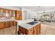 Open kitchen features a central island with a cooktop, bar seating, and seamless flow into the living space at 215 Great Gable Dr, Las Vegas, NV 89183