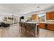 Open kitchen with an island bar, tile floors, and modern appliances adjacent to a spacious living area at 215 Great Gable Dr, Las Vegas, NV 89183