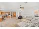 Open concept living area with plush sectional, desk space, and connected kitchen at 215 Great Gable Dr, Las Vegas, NV 89183