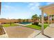 Inviting backyard oasis featuring a sparkling pool, lush landscaping, and a cozy pergola at 215 Great Gable Dr, Las Vegas, NV 89183