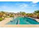 Stunning backyard oasis with a sparkling pool, lush landscaping, and ample space for recreation at 215 Great Gable Dr, Las Vegas, NV 89183