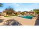 Resort-style backyard featuring a sparkling pool, lush landscaping, and luxurious amenities at 215 Great Gable Dr, Las Vegas, NV 89183