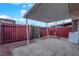 Outdoor area features a covered patio, providing a shaded space for relaxation or entertaining and enclosed by a wooden fence at 241 E Van Wagenen St, Henderson, NV 89015