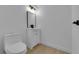 A well-lit bathroom features a modern vanity, toilet, and neutral color palette, complemented by stylish light fixtures at 241 E Van Wagenen St, Henderson, NV 89015