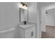 A modern bathroom with a single sink, white cabinets, and a black faucet at 241 E Van Wagenen St, Henderson, NV 89015
