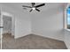 A bedroom with neutral carpet, a ceiling fan, and a bathroom at 241 E Van Wagenen St, Henderson, NV 89015