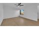 Comfortable bedroom with neutral walls, modern fan, wood-look floors, and a sunny window, creating a cozy retreat at 241 E Van Wagenen St, Henderson, NV 89015