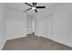 A bedroom with neutral carpet, a ceiling fan, and a closet with sliding doors at 241 E Van Wagenen St, Henderson, NV 89015