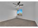 A bright room with neutral carpet and a window lets in natural light with mountain views at 241 E Van Wagenen St, Henderson, NV 89015