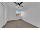 A bright room with neutral carpet and a window lets in natural light with desert views at 241 E Van Wagenen St, Henderson, NV 89015