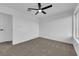 A bedroom with neutral carpet, a ceiling fan, and two windows lets in natural light at 241 E Van Wagenen St, Henderson, NV 89015