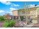 Charming two-story townhome with well-maintained landscaping and inviting curb appeal under a bright, partly cloudy sky at 241 E Van Wagenen St, Henderson, NV 89015