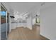 Modern kitchen featuring white cabinets, sleek countertops, stainless steel sink, and wood-look floors with backyard view at 241 E Van Wagenen St, Henderson, NV 89015