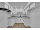 Modern kitchen with white cabinets, grey countertops, and stainless steel appliances, maximizing space and efficiency at 241 E Van Wagenen St, Henderson, NV 89015