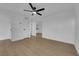 Inviting living room featuring a ceiling fan, wood-look floors, and neutral paint, creating a bright and airy space at 241 E Van Wagenen St, Henderson, NV 89015