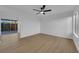 Bright living room featuring modern ceiling fan, wood-look floors, and sliding doors to the backyard at 241 E Van Wagenen St, Henderson, NV 89015
