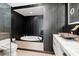 Modern bathroom featuring a soaking tub, designer tile, and a unique marble sink at 2700 Las Vegas Blvd # 1401, Las Vegas, NV 89109