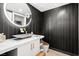 This modern bathroom has a black and gold accent wall with a marble sink at 2700 Las Vegas Blvd # 1401, Las Vegas, NV 89109