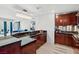 Kitchen area has dark wood cabinets, granite countertop and undermount sink with tile flooring at 2700 Las Vegas Blvd # 1401, Las Vegas, NV 89109