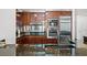 Modern kitchen features sleek wood cabinets, stainless steel appliances, and dark granite countertops at 2700 Las Vegas Blvd # 1401, Las Vegas, NV 89109