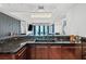 This contemporary kitchen has dark wood cabinets, granite counters, and a view of the city at 2700 Las Vegas Blvd # 1401, Las Vegas, NV 89109