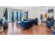 A modern living room with a dark blue, tufted sofa and hardwood floors at 2700 Las Vegas Blvd # 1401, Las Vegas, NV 89109