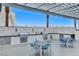 Outdoor kitchen equipped with stainless steel grills, a sink, and dining tables with seating at 2700 Las Vegas Blvd # 1401, Las Vegas, NV 89109