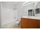 Well-lit bathroom featuring a shower-tub combo and a wood vanity with a white countertop at 2839 Strathallan Ave, Henderson, NV 89044