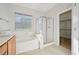Bathroom featuring a double vanity, a soaking tub, and a glass shower at 2839 Strathallan Ave, Henderson, NV 89044