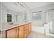 Bright bathroom with double vanity, soaking tub, and a glass enclosed shower at 2839 Strathallan Ave, Henderson, NV 89044