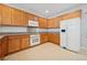 Cozy kitchen features wood cabinets, granite counters, and white appliances at 2839 Strathallan Ave, Henderson, NV 89044
