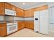 Charming kitchen with wood cabinets, granite counters and white appliances at 2839 Strathallan Ave, Henderson, NV 89044