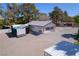 A view of a detached garage/workshop with a concrete driveway and lean-to attached at 2900 Thurman Ave, Las Vegas, NV 89120