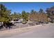 Charming property featuring a fenced yard with mature trees enhancing the curb appeal and privacy at 2900 Thurman Ave, Las Vegas, NV 89120