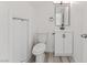 Small bathroom with a toilet, sink, vanity, mirror, and storage shelves at 2915 Cedar Ave # 12C, Las Vegas, NV 89101