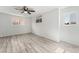 Bright bedroom featuring two windows, a ceiling fan, and wood-look flooring at 2915 Cedar Ave # 12C, Las Vegas, NV 89101