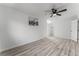 Clean bedroom with ceiling fan, light wood floors, and closet access at 2915 Cedar Ave # 12C, Las Vegas, NV 89101