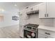 Contemporary kitchen featuring stone countertops, stainless steel appliances, and white cabinets at 2915 Cedar Ave # 12C, Las Vegas, NV 89101