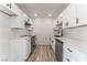 Updated kitchen featuring white cabinets, stainless steel appliances, and modern countertops at 2915 Cedar Ave # 12C, Las Vegas, NV 89101