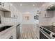 Modern kitchen with stainless steel appliances, stone countertops, and white cabinetry at 2915 Cedar Ave # 12C, Las Vegas, NV 89101