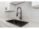 Close-up of a kitchen sink with a black faucet and stone countertop at 2915 Cedar Ave # 12C, Las Vegas, NV 89101