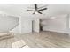 Bright living room with new floors, stairs, and white trim, leading to the kitchen at 2915 Cedar Ave # 12C, Las Vegas, NV 89101